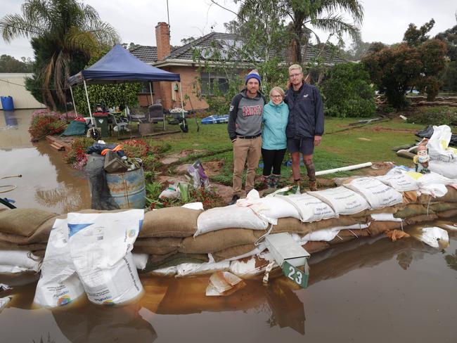 Natalie Murphy has been fighting to keep water out of her father’s house with her brother Dallas and son Riley. Picture: David Caird