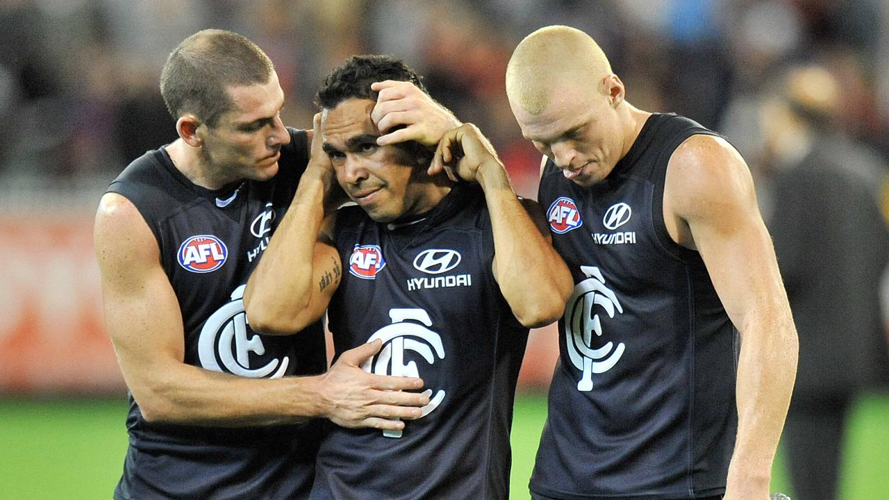 Heath Scotland and Mitch Robinson console Eddie Betts after a loss when the three players were all at Carlton.