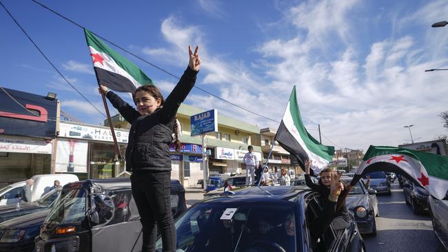 Syrians celebrate the fall of Bashar Assad's government. Picture: AP Photo/Hassan Ammar