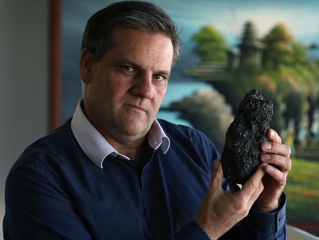 Peter Lynch , Chair and CEO of COKAL ,  sold his interest in coal mining in QLD's Galilee Basin and now concentrates on coal mining in Indonesia , with Indonesian artwork behind him in the boardroom of COKAL , in the Brisbane CBD.