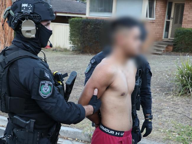 Police with 22-year-old Bradbury man Jaeden Tito in custody. Picture: NSW Police