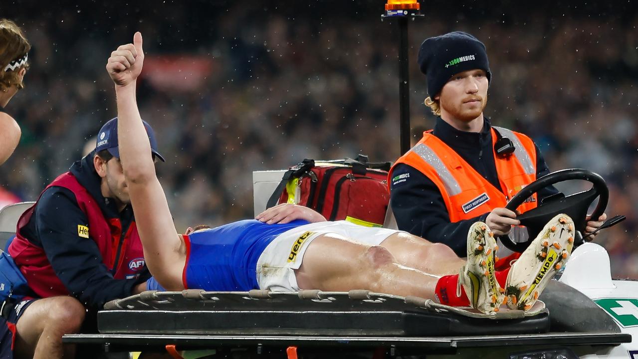 Angus Brayshaw gives the crowd the thumbs up after leaving the field on a stretcher. Picture: Dylan Burns