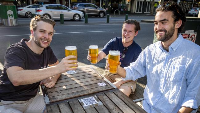 Generic pics of people dining out.  Melbourne cafe generic. Melbourne restaurant generic. Will Keenan, Callum McDermot and Fergus Morrison enjoy a beer on Lygon Street. Picture: Jake Nowakowski