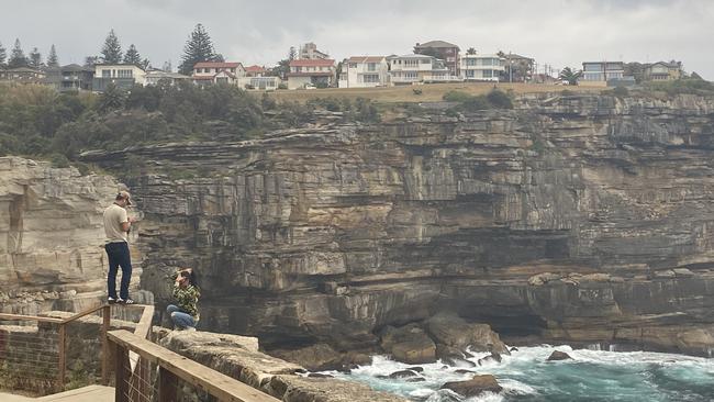 Tourists who climbed the fence at Diamond Bay on Sunday.