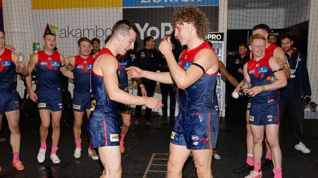 Debutant Kynan Brown (left) and second-gamer Koltyn Tholstrup celebrate their first wins for Melbourne after the three-point victory over the Kangaroos on Saturday night. Picture: Dylan Burns / Getty Images