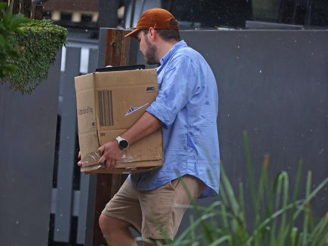 Dressed in a polo shirt and sandals, Mr Lehrmann was again joined by two mates including sailor Rob Porter as he moved unti his new place.