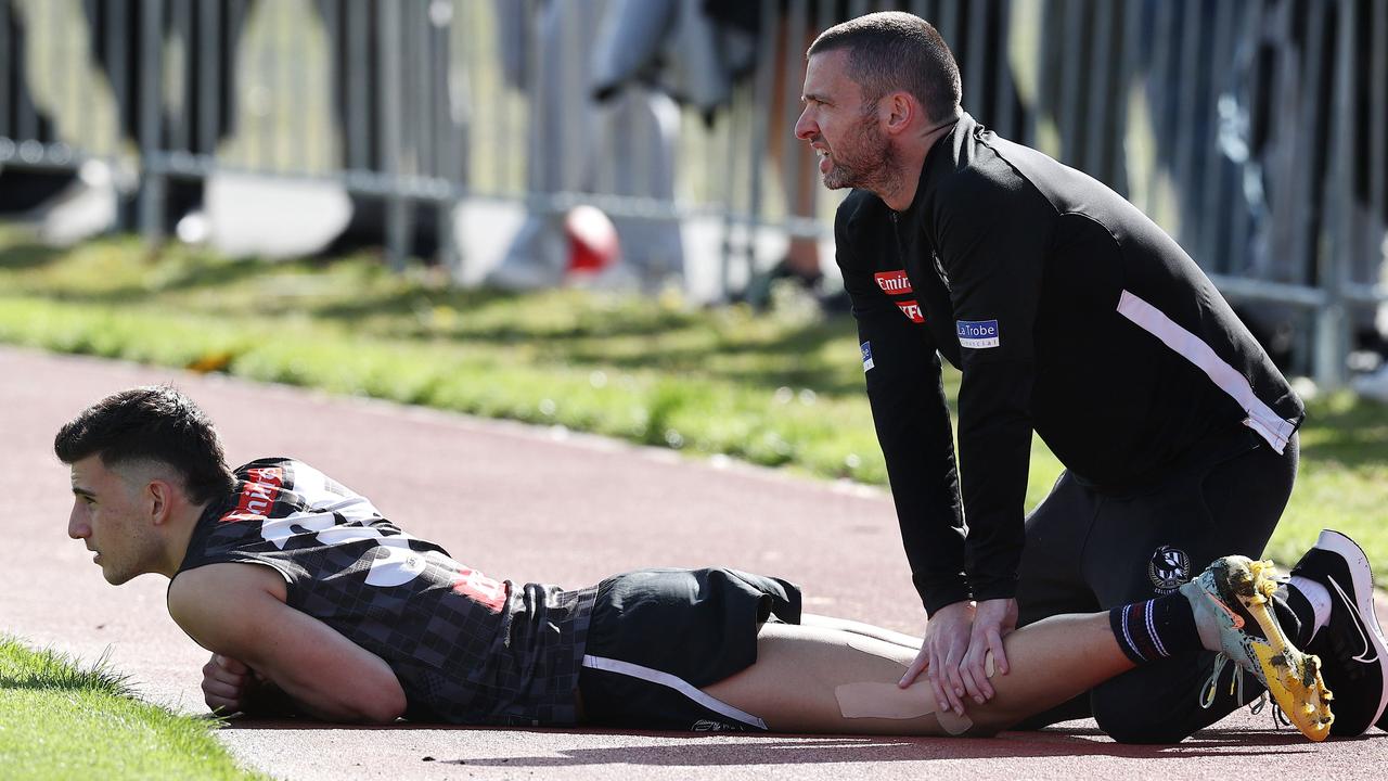 Nick Daicos of the Magpies gets worked on by a physiotherapist mid session. Picture by Michael Klein