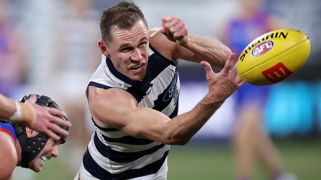 Joel Selwood escapes a Caleb Daniel tackle to get his handball away in his 350th game. Picture: Mark Stewart