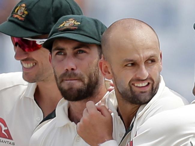 Teammates congratulate Australia's Nathan Lyon, second right, after the dismissal of Bangladesh's Shakib Al Hasan during the fourth day of their second test cricket match in Chittagong, Bangladesh, Thursday, Sept. 7, 2017. (AP Photo/A.M. Ahad)