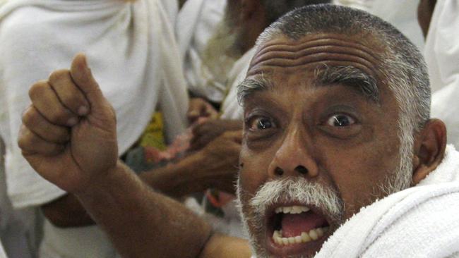 A Muslim pilgrim follows tradition in throwing pebbles at a stone pillar representing the devil, during his Hajj pilgrimage in Mecca. Picture: AP