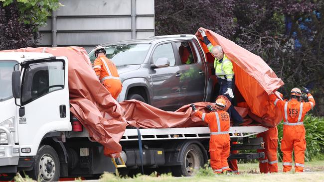 SES wrap a car believed to be involved in the shooting. Picture: David Crosling