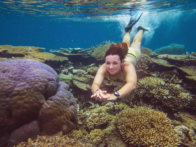 27/09/2016 Heather Baird, 24 year old dive master from the reef boat Calypso, swims amongst the corals at Opal reef on the Great Barrier Reef off the coast of Port Douglas. Brian Cassey/The Australian