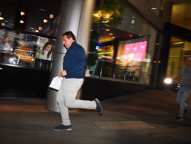 Mark Thompson flees after leaving Melbourne Magistrates’ Court. Picture: AAP/James Ross