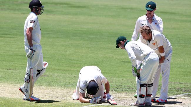 Adam Voges sinks to the ground after being hit by Cameron Stevenson.