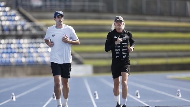 Australian cricket captain Pat Cummins joined Brockmann for a few laps at Sydney Olympic Park on Friday morning. He’s had other supporters, including boxer Harry Garside, run alongside him in support in the past week. Picture: Richard Dobson