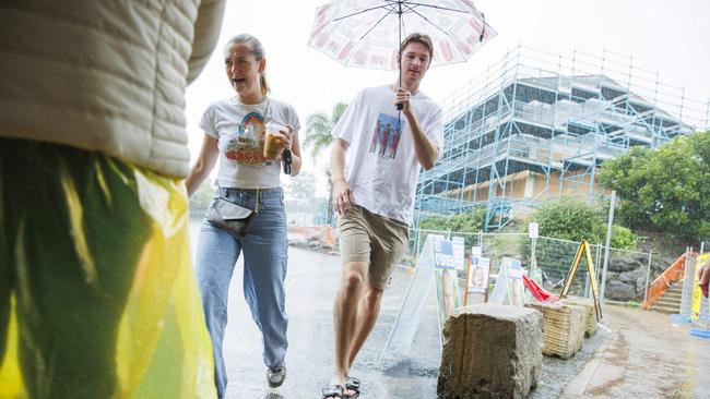 Fairfax voters braved the torrential rain to cast their choice in the 2022 Federal Election at Maroochydore High School. Picture: Lachie Millard