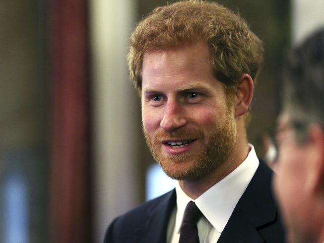 Prince Harry speaks to guests during the Queen's Young Leaders Awards dinner at Australia House. Picture: AP