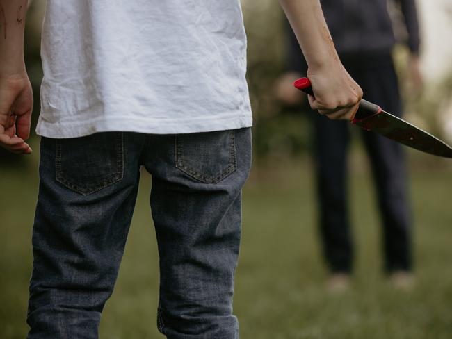 File picture of a youth holding a knife.