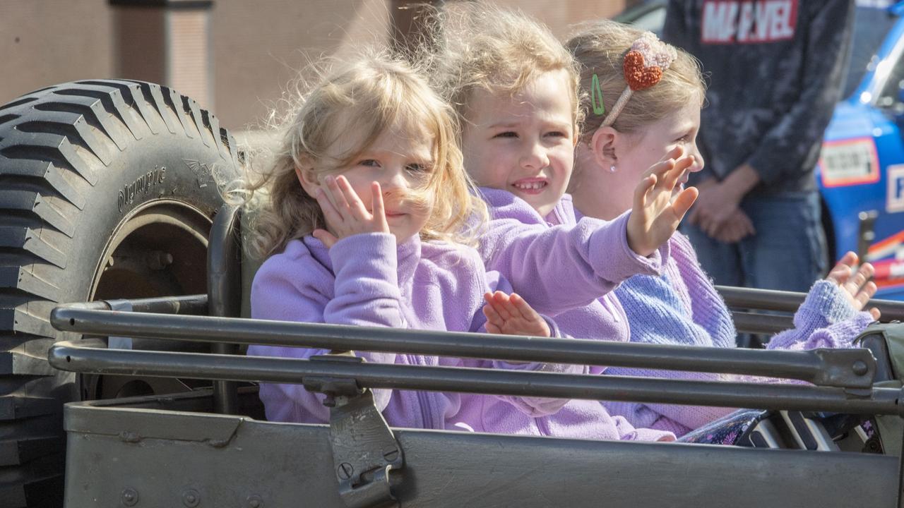 (from left) Ella Connolly, Chloe Connolly and Peyton Locke with her grandfathers medals. Assembly in Neil St for the mid morning parade on ANZAC DAY. Tuesday, April 25, 2023. Picture: Nev Madsen.