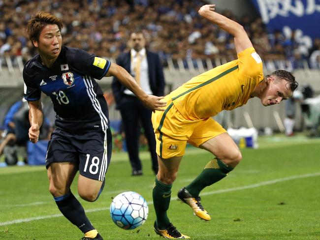 Japan's Takuma Asano gets away from Australia’s Brad Smith during their World Cup qualifier on Thursday night.