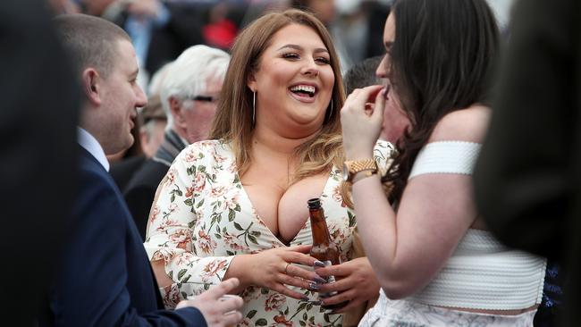 A female racegoer enjoys a drink during day one of the Randox Health Grand National Festival at Aintree Racecourse. David Davies/PA Wire