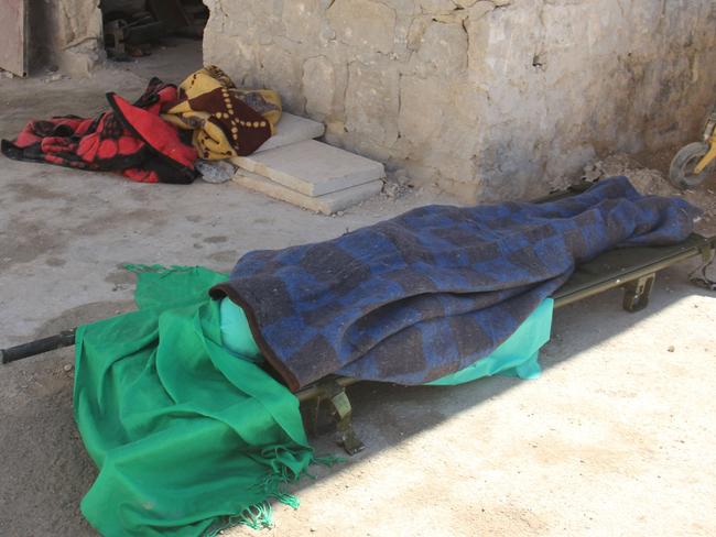 A covered body lies outside a hospital in Khan Sheikhun, a rebel-held town in the northwestern Syrian Idlib province, following a suspected toxic gas attack. Picture: AFP/Omar haj kadour