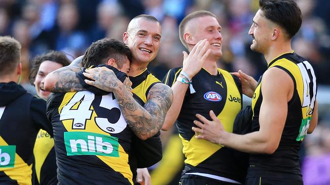 Dustin Martin embraces VFL teammate Patrick Naish after the final siren.