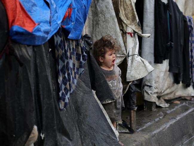 A Palestinian child stands at the entrance of a tent in an area housing displaced people in Rafah. Picture: AFP