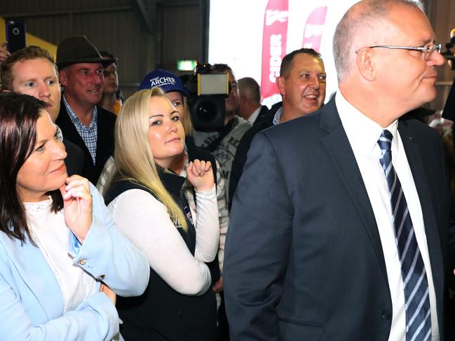 Former Liberal, now independent candidate Jessica Whelan carries an umbrella for the Prime Minister Scott Morrison on day 22 campaigning in Tasmania with his wife Jenny at an Agriculture festival. Picture Gary Ramage