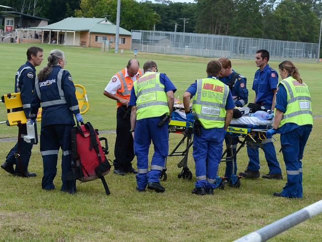Paramedics working on one of the injured family members. Picture: Mark Scott