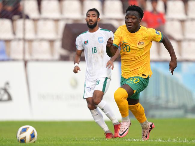 DHAKA, BANGLADESH - JUNE 06: Nestory Irankunda of Australia (R) chases the ball under pressure of Isa Faysal of Bangladesh (L) during the FIFA World Cup Asian second qualifier Group I match between Bangladesh and Australia at Bashundhara Kings Arena on June 6, 2024 in Dhaka, Bangladesh. (Photo by Thananuwat Srirasant/Getty Images)