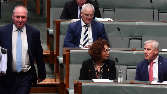 Former Deputy Prime Minister Michael McCormack (right) watches as Deputy Prime Minister Barnaby Joyce (left) arrives during Question Time in the House of Representatives at Parliament House on June 23, 2021. Mr Joyce says he has not seen what  effect net zero emissions wil have on regional Australia. Picture:  Getty