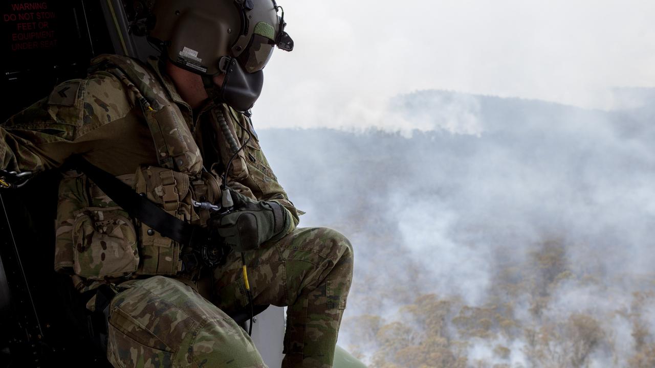 An Australian Army 5th Aviation Regiment loadmaster observes the area near Mount Ginini close to the New South Wales and Australian Capital Territory border..