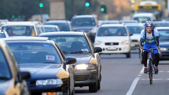 Commuter cyclist Arthur Konstad riding his bike home in city traffic from his work in the Adelaide CBD to Plympton.