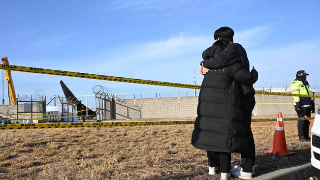 Mourners react near the scene where a Jeju Air Boeing 737-800 series aircraft crashed and burst into flames at Muan International Airport after hitting a concrete block wall. Picture: AFP