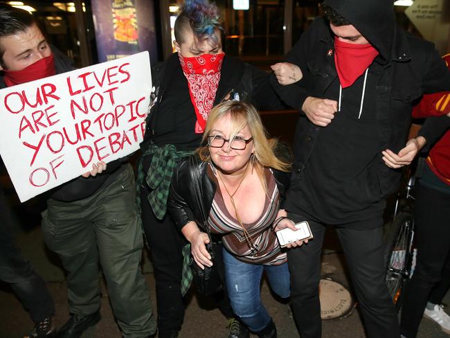 A woman tries to break through student protesters to reach an Australian Christian Lobby seminar against the contentious Safe Schools program. Picture: Ian Currie