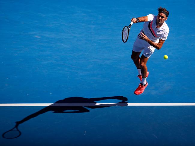 MELBOURNE, AUSTRALIA - JANUARY 22:  Roger Federer of Switzerland serves in his fourth round match against Marton Fucsovics of Hungary on day eight of the 2018 Australian Open at Melbourne Park on January 22, 2018 in Melbourne, Australia.  (Photo by Darrian Traynor/Getty Images)