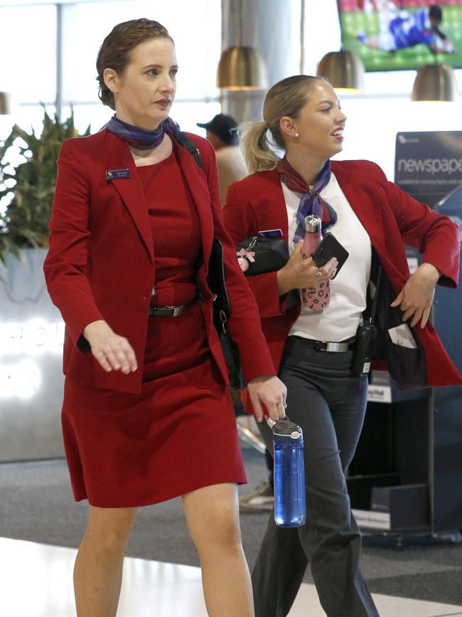 Virgin Australia staff members at the Brisbane Domestic Airport on Friday. All airlines, including Virgin, are trying to reassure passengers that their planes are clean in the wake of the COVID-19 pandemic. Picture: Steve Pohlner