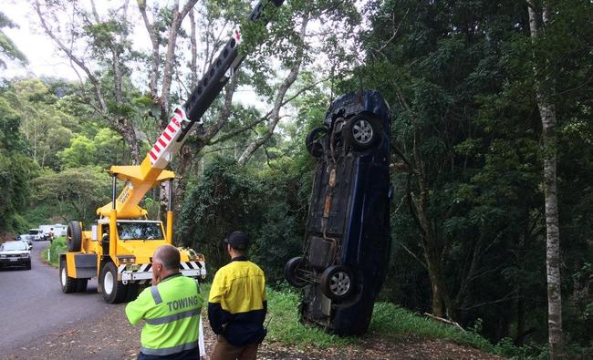 A crane was used to retrieve a car from down a 30-foot embankment off Tuntable Creek Road.. Picture: Marc Stapelberg