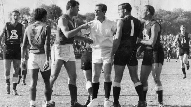 Neil Kerley, right, remonstrates with Neil Hawke of West Torrens as umpire Ken "KG" Cunningham intervenes.