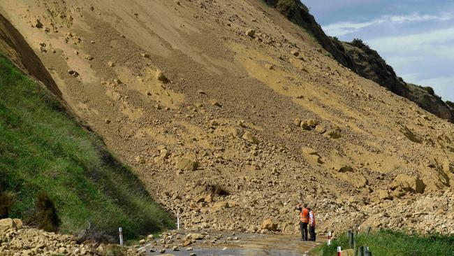 Road to nowhere: Emergency services officers inspect the damage caused to Rotherham Road near Waiau town, 90 kms to the south of Kaikoura. Picture: AFP/Matias Delacroix