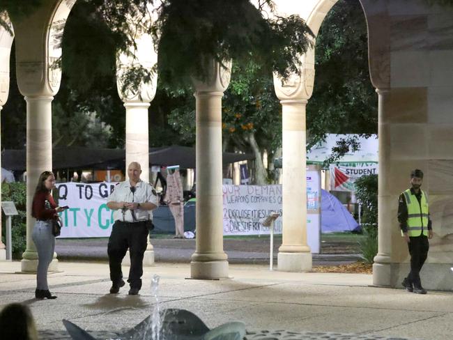 Security guards stop people entering UQ’s Great Court after a bomb hoax on Wednesday. Picture: Steve Pohlner