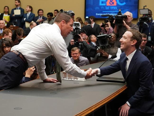 Facebook CEO Mark Zuckerberg, right, greets Republican Markwayne Mullin. Picture: AP