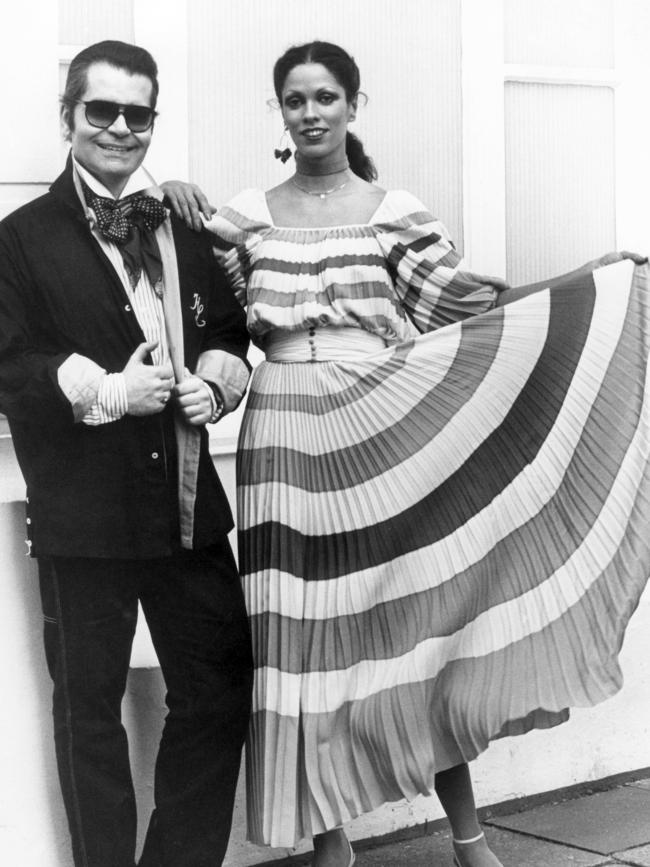 Karl Lagerfeld, left, poses with a model in Hamburg in 1977. Picture: AP