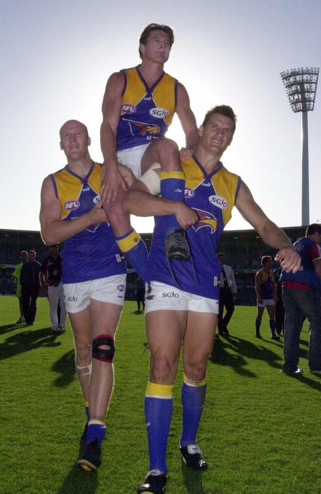 Cousins is chaired off of Subiaco Oval by veteran team mates Ashley McIntosh (l) and Glen Jakovich after playing his 150th game Picture: Jackson Flindell