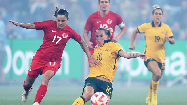 Emily van Egmond of the Matildas is challenged by Jessie Fleming of Canada.