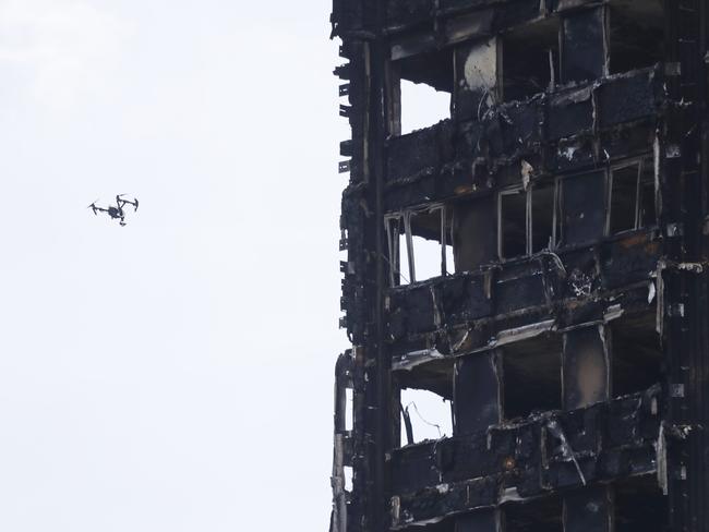 A drone checks on the burnt out building. Picture: AP