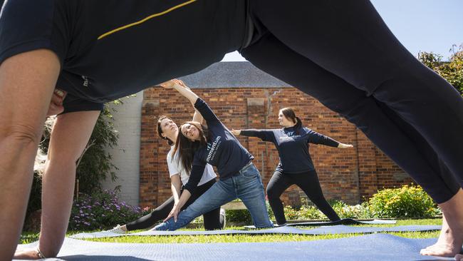 Antara Studios owner Amy Pattison instructs Momentum Mental Health CEO Shirley-Anne Gardiner while Ellen Baldwin (back) and Ang Latham (front) work on their form in preparation for Mates on Mats 24hr yoga marathon fundraiser for Momentum Mental Health in collaboration with Antara Studios, Thursday, October 17, 2024. Picture: Kevin Farmer