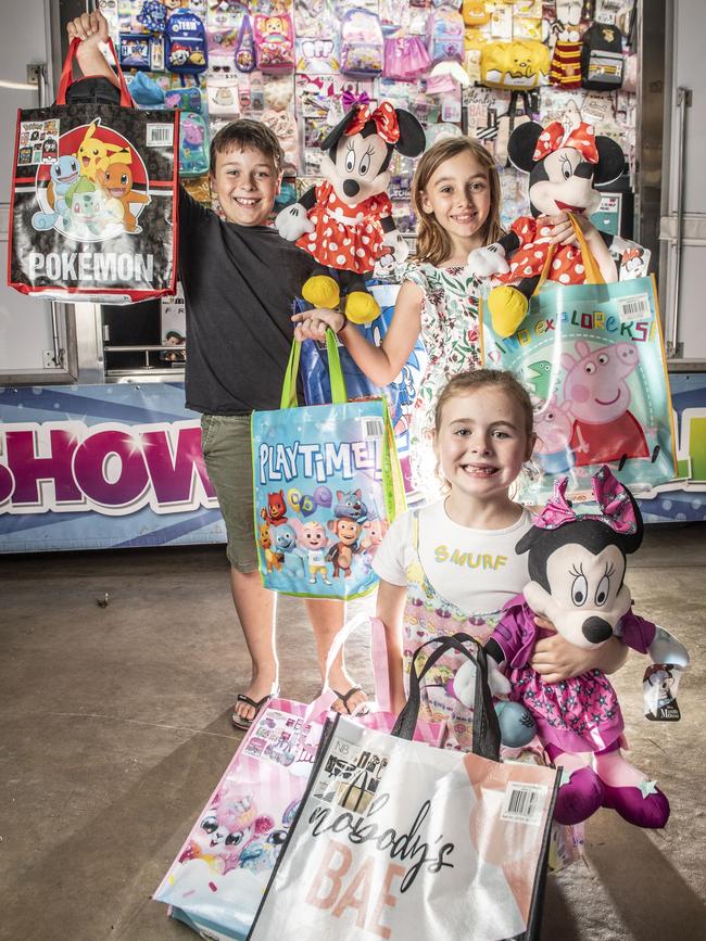 (from back to front) Ty, Addison and Harpah Phillips enjoy a sneak peek at some of the new showbags on offer at the 2023 Toowoomba Royal Show. Picture: Nev Madsen