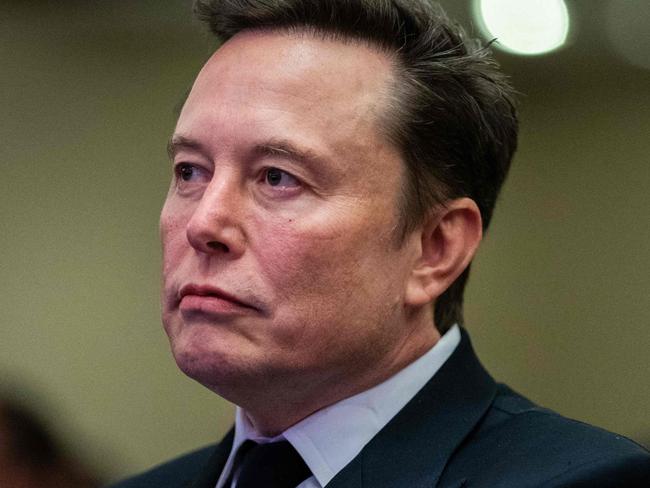 TOPSHOT - Elon Musk listens as US President-elect Donald Trump speaks during a meeting with House Republicans at the Hyatt Regency hotel in Washington, DC on November 13, 2024. (Photo by Allison ROBBERT / POOL / AFP)